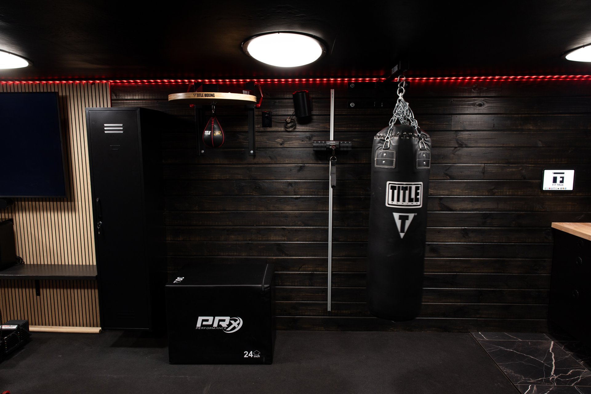 Training attachments organized on the gym trailer wall