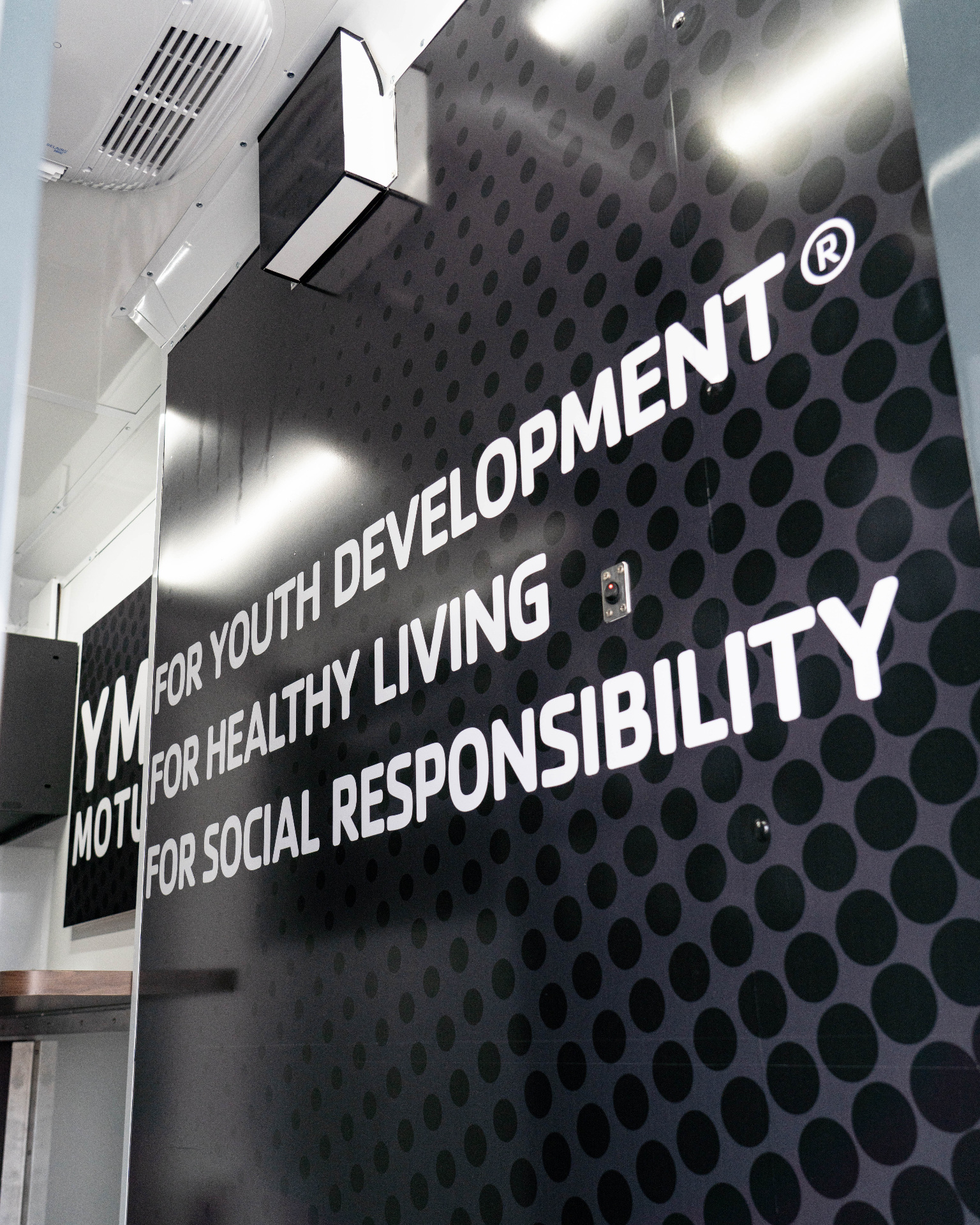 Interior wall carrying the YMCA slogan: for youth development, for healthy living, for social responsibility