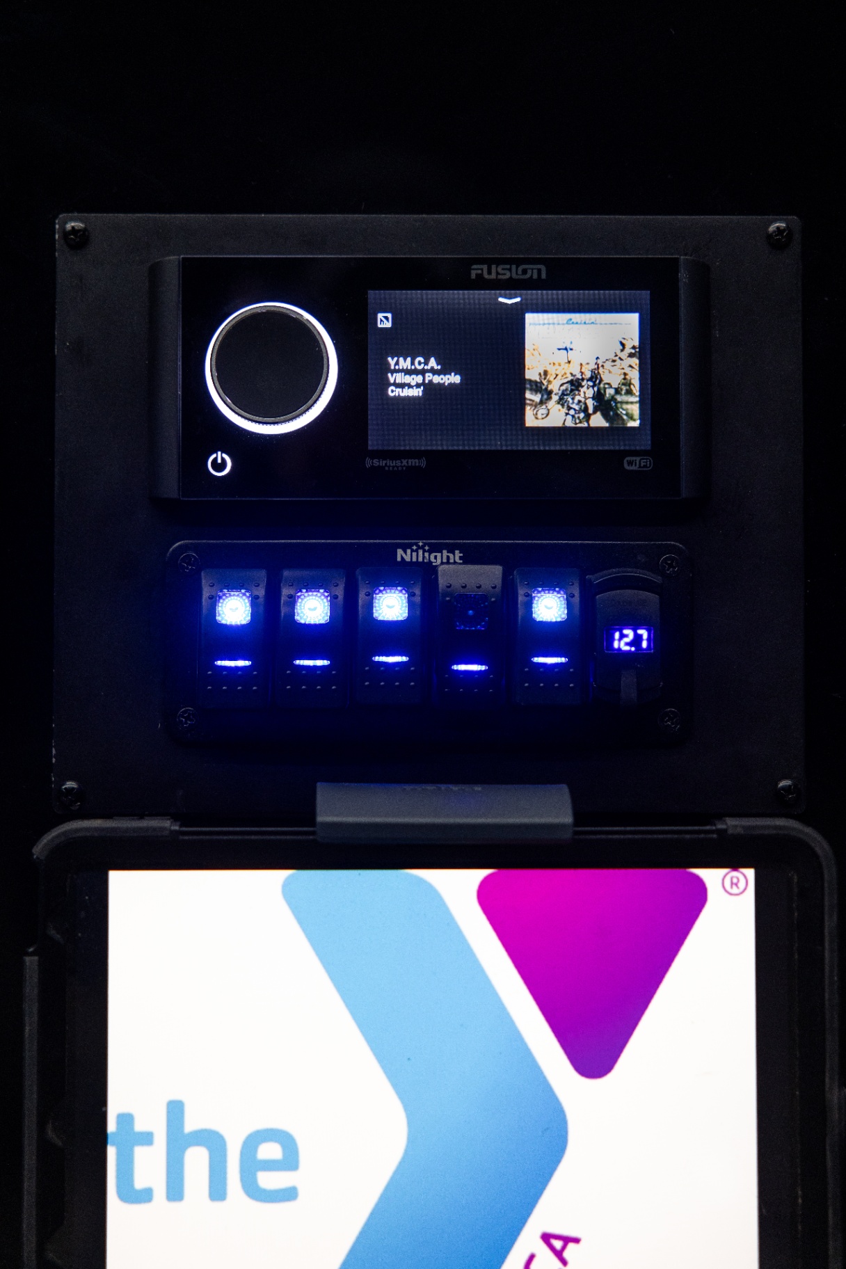 Fusion audio display, illuminated lighting switches and YMCA screen inside the Fit Truk