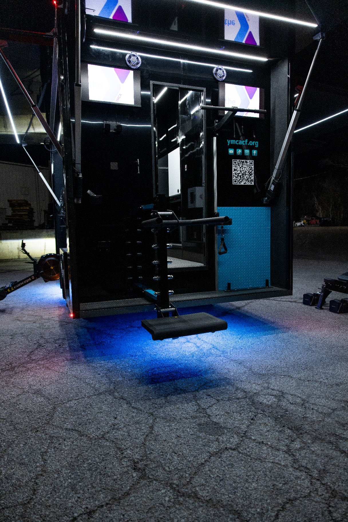 Rear training station with deployed equipment beneath the YMCA Fit Truk canopy