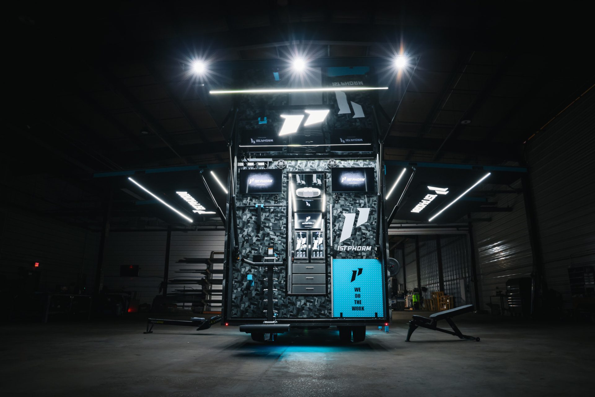 1st Phorm-branded Fit Truk build lit up in the shop with awnings open