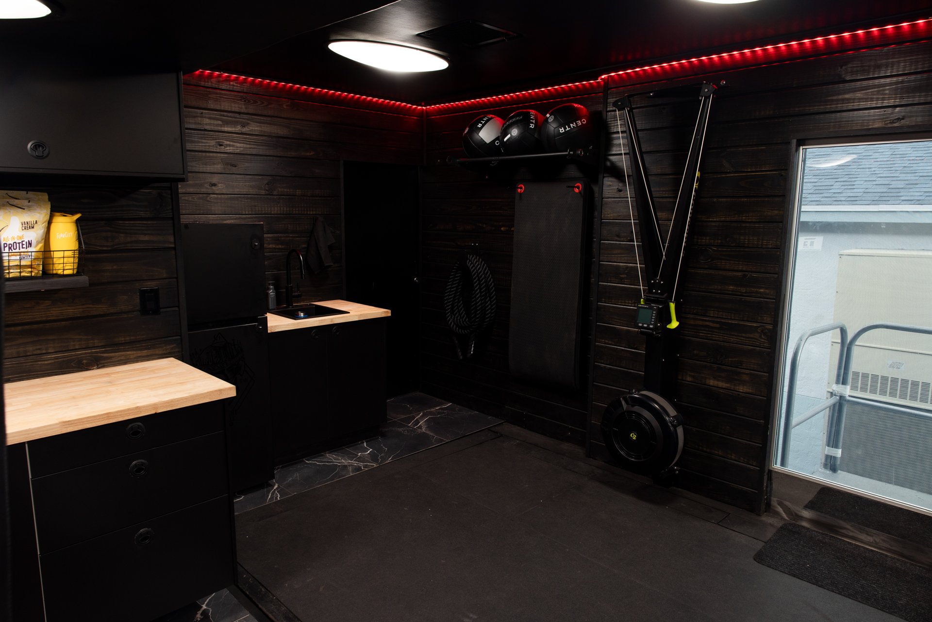 Gym trailer entry area with counter and equipment wall