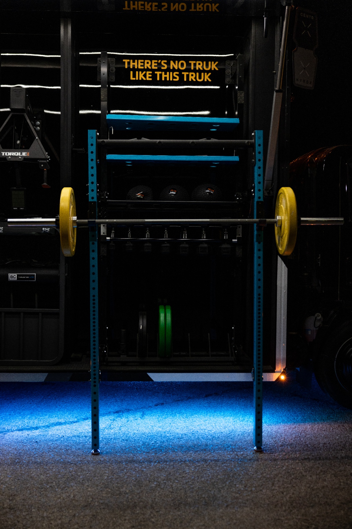 Deployed squat rack with a loaded barbell outside the YMCA Fit Truk