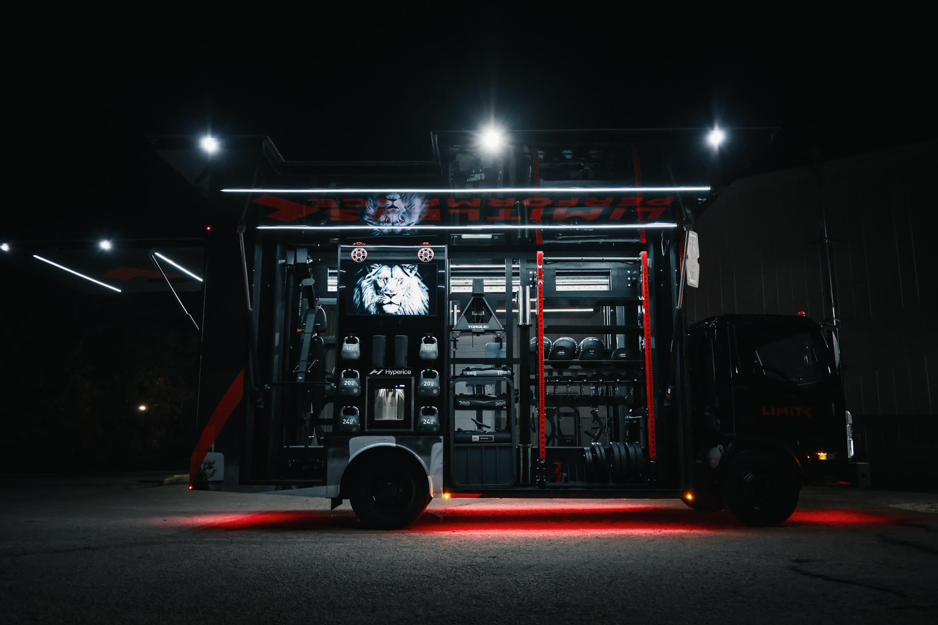 Fit Truk 2.0 deployed at night with side canopy open, equipment lit by integrated LEDs